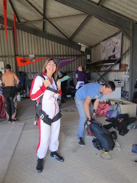 Natalie all suited up and ready to go. Mikey her tandem master behind her getting the parachute ready.