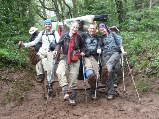 Muddy and dirty but still full of smiles ~ who cared what we looked like we just summited Kilimanjaro! Photo by Judi Kurgan