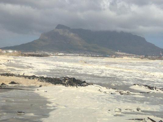 The foam on the shoreline with Table Mountain in the background.