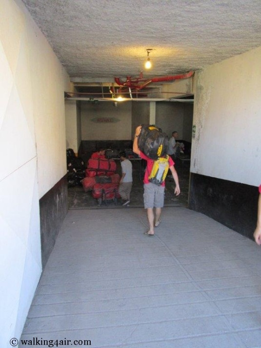 Moving our duffel bags down into the basement of our overnight stop. 